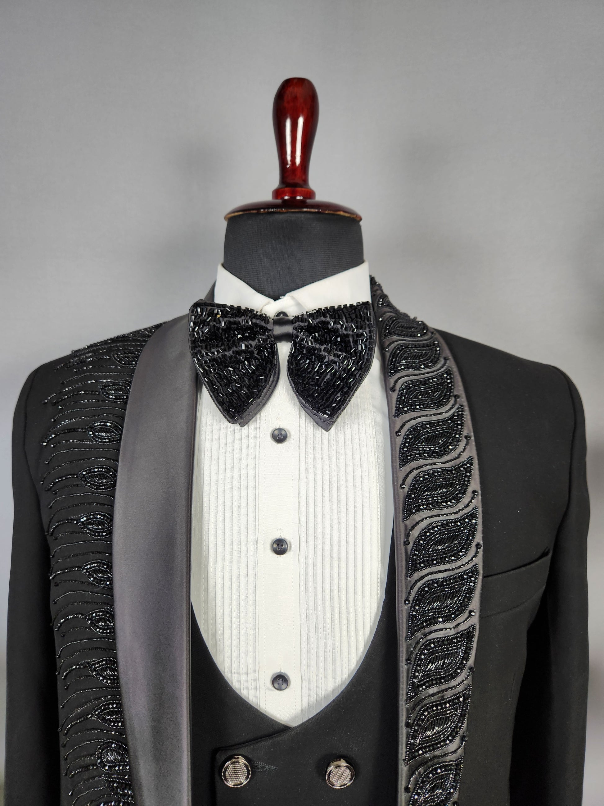 Men's black tuxedo suit for Indian groom, perfect for wedding and reception wear
