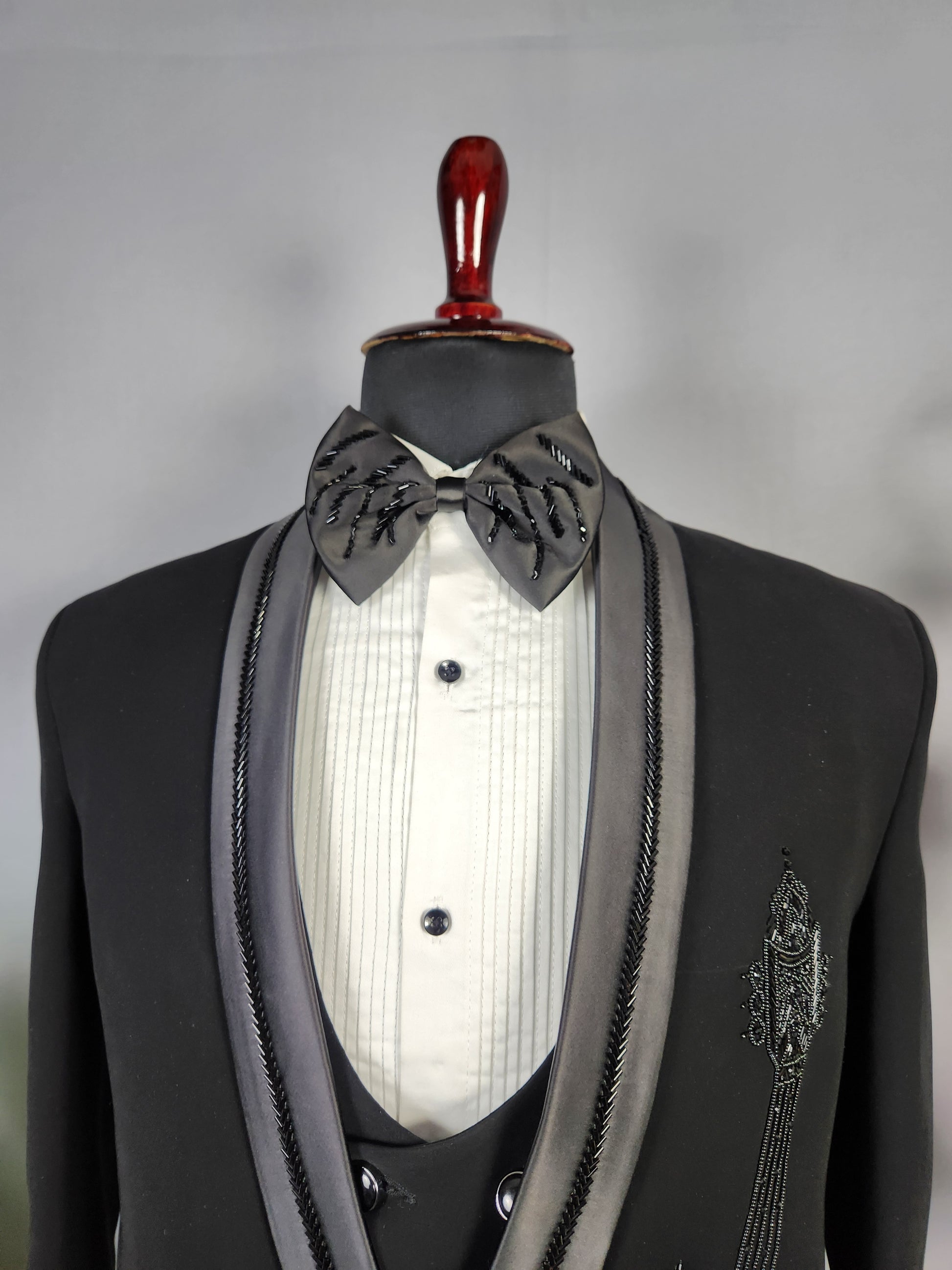 Men's black tuxedo suit for Indian groom, perfect for wedding and reception wear
